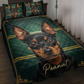 Miniature Pinscher quilt blanket displayed on a bed with black, green, and gold artwork