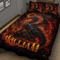 Close bedroom view of a fiery black and red dragon quilt blanket with fantasy artwork