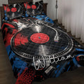 DJ quilt blanket displayed on a bed with turntables, vinyl records, and bold red, blue, and black artwork