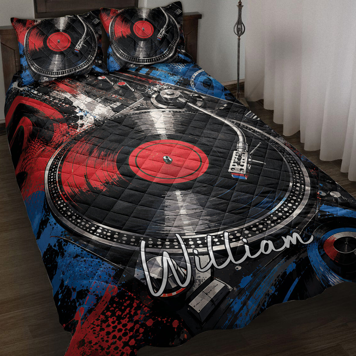 DJ quilt blanket displayed on a bed with turntables, vinyl records, and bold red, blue, and black artwork