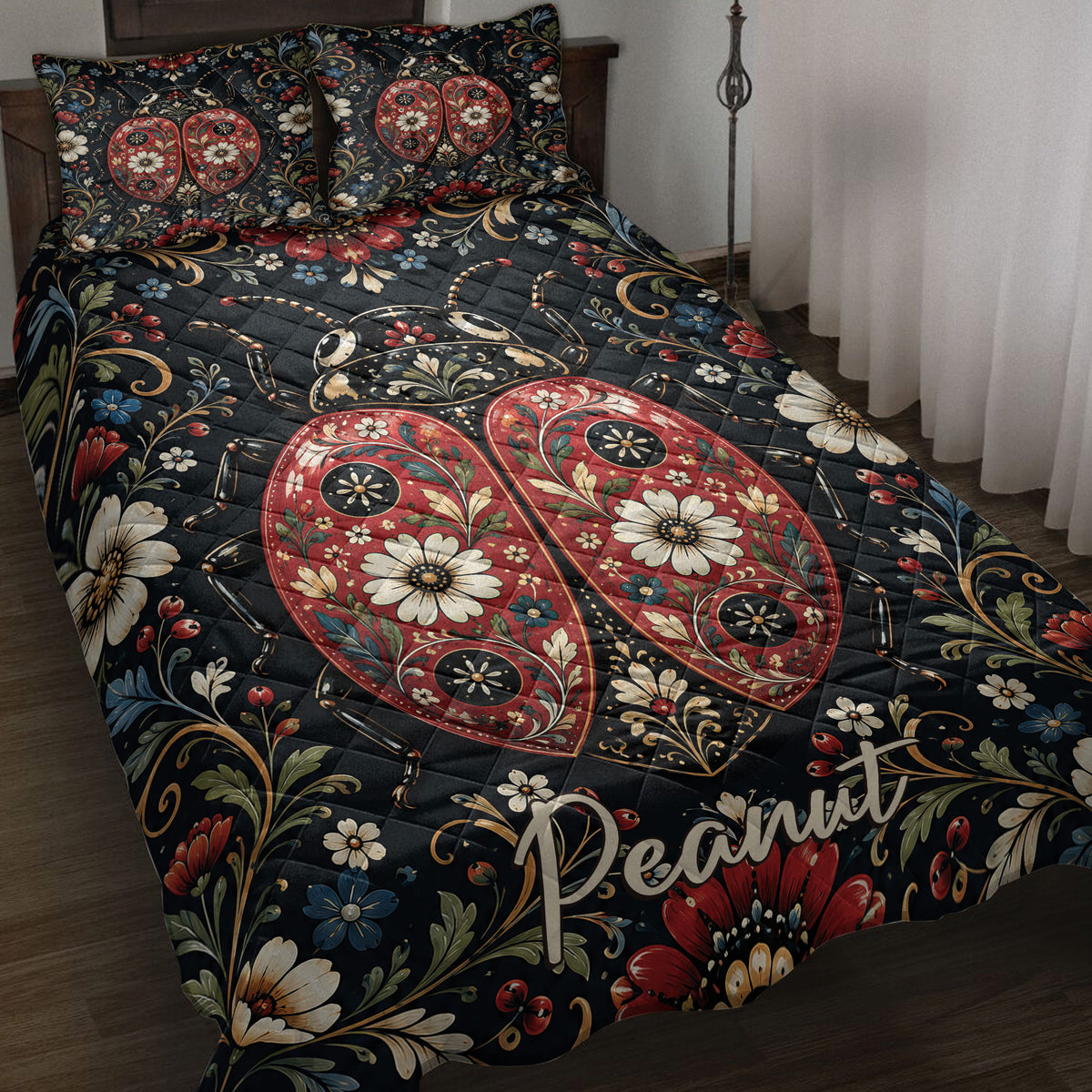 Ladybug quilt blanket spread across a bed with ornate floral artwork in black, red, blue, and cream