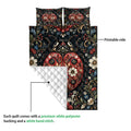 Ladybug quilt blanket shown with a printed floral front and white quilted backing detail