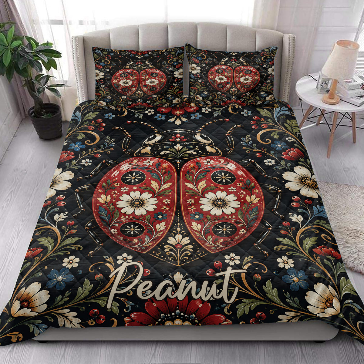 Ladybug quilt bedding styled in a bright bedroom with floral artwork and bold red heart-shaped wings