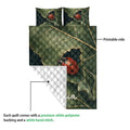 Ladybug quilt blanket detail showing the printed leafy side and white quilted backing