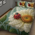 Close view of a ladybug quilt blanket with large daisies, leaves, and vibrant garden artwork