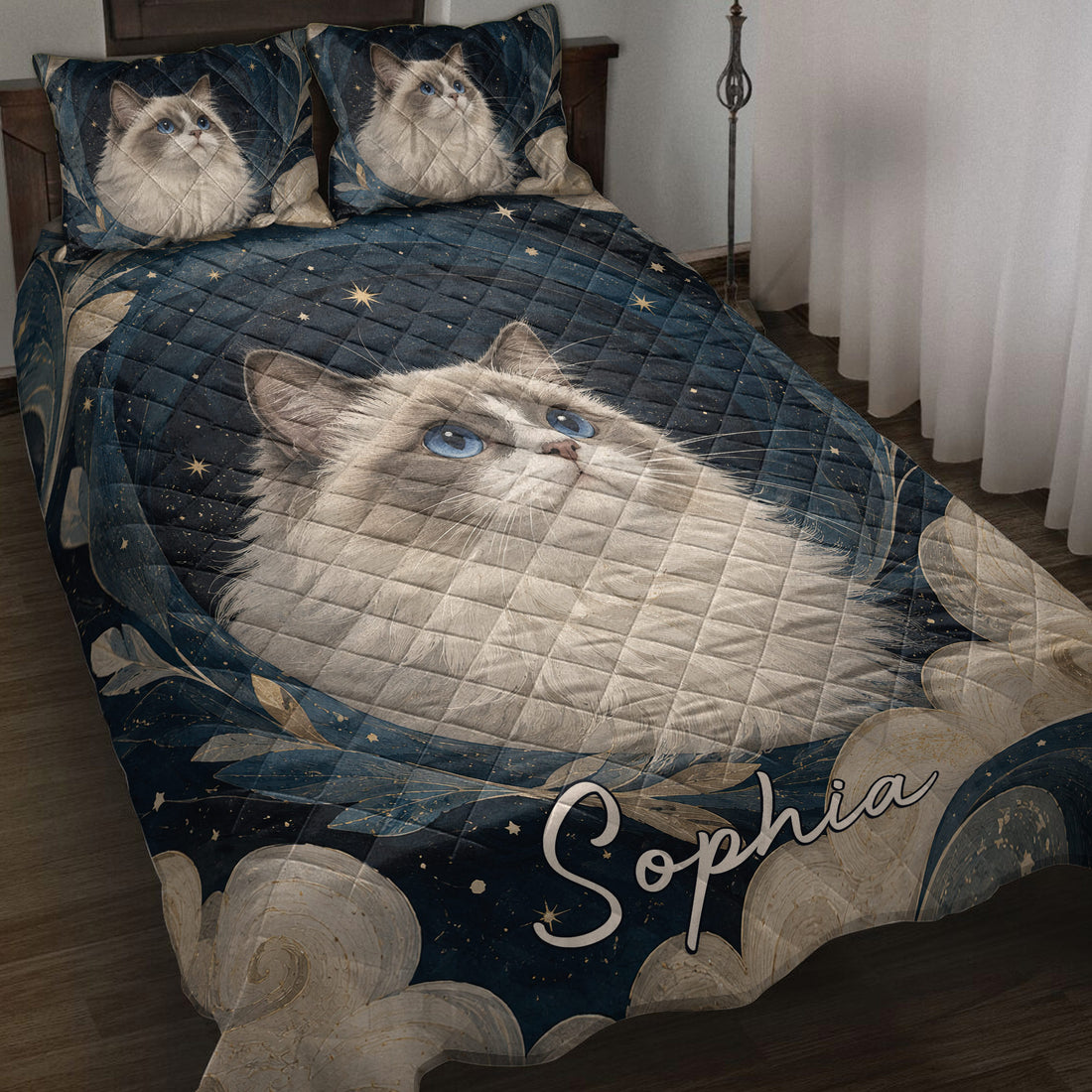 Ragdoll cat quilt blanket displayed on a bed with blue eyes, stars, leaves, and dark blue artwork