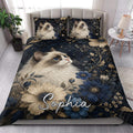 Ragdoll cat quilt blanket styled in a bright bedroom with blue and cream floral bedding