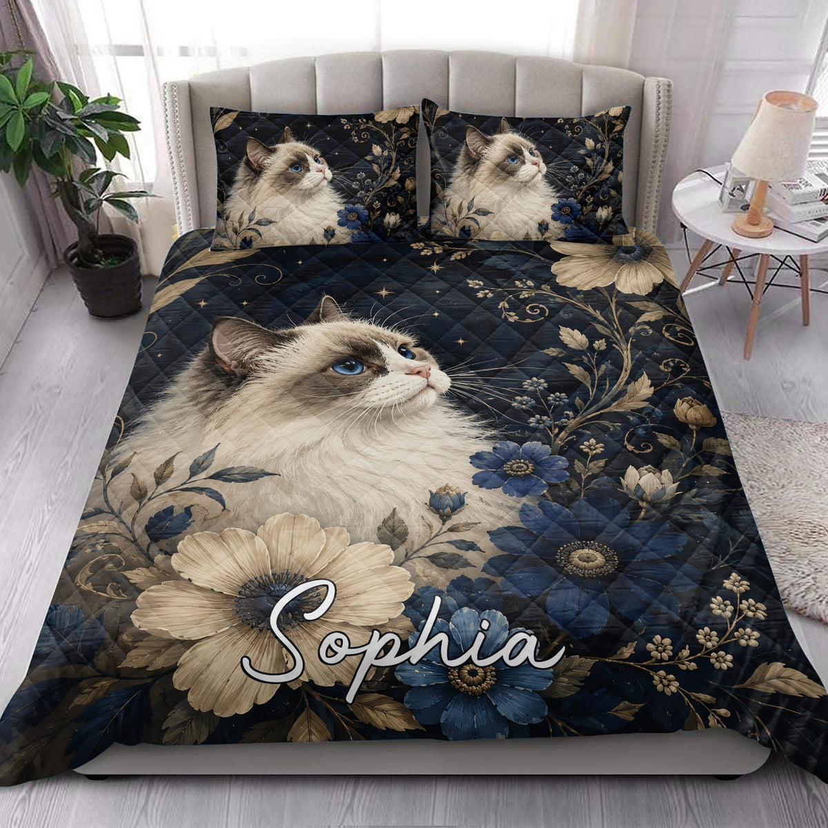 Ragdoll cat quilt blanket styled in a bright bedroom with blue and cream floral bedding