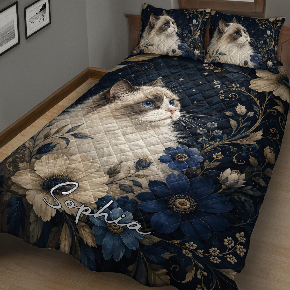 Ragdoll cat quilt blanket displayed on a bed with botanical flowers and deep blue floral details