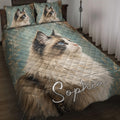 Ragdoll cat quilt blanket styled on a bed with matching cat pillow designs in teal and gold