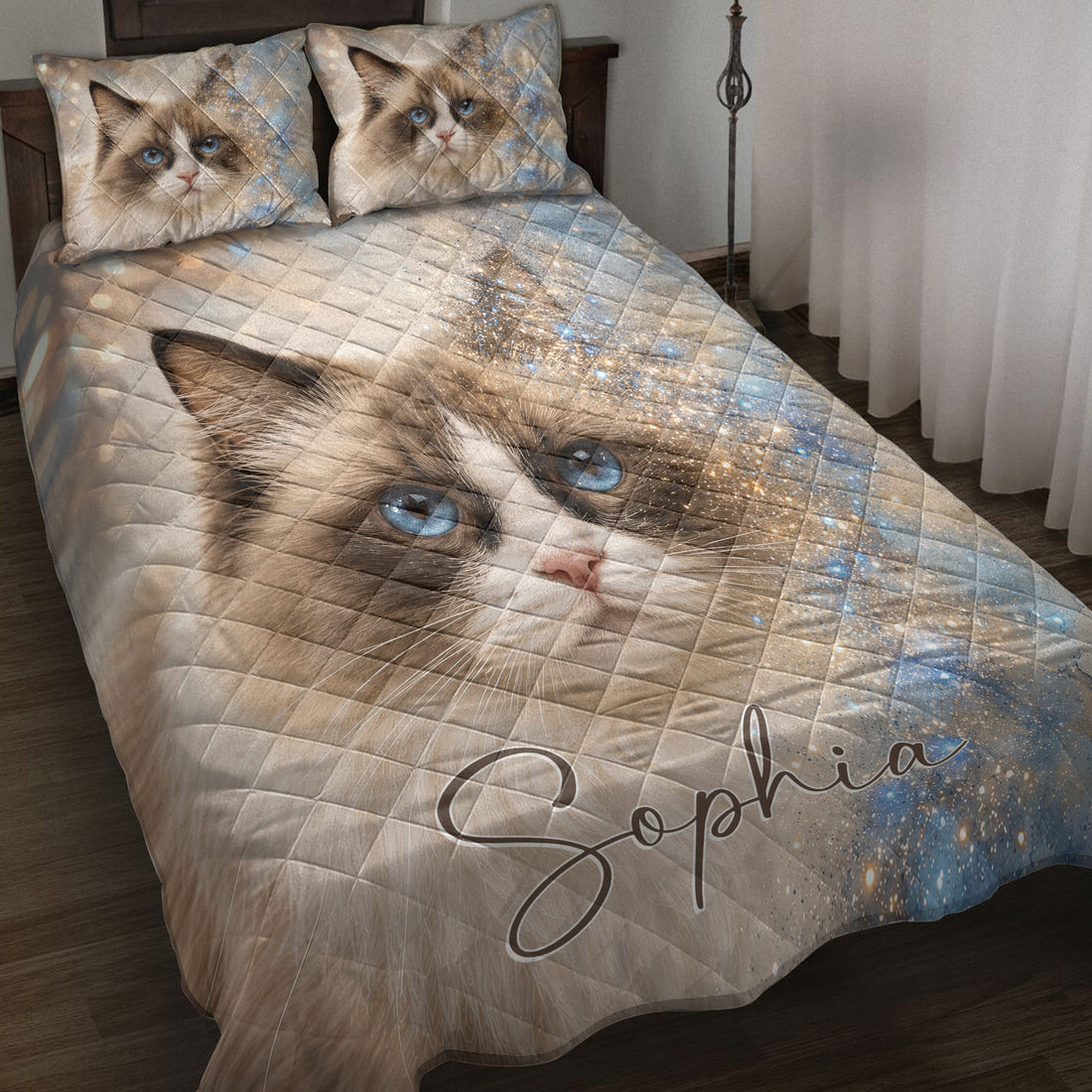 Ragdoll cat quilt blanket displayed on a bed with blue eyes, sparkle accents, and matching cat artwork