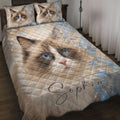 Ragdoll cat quilt blanket displayed on a bed with blue eyes, sparkle accents, and matching cat artwork