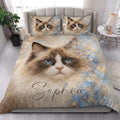 Ragdoll cat quilt blanket styled in a bright bedroom with large blue-eyed cat artwork