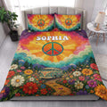 Hippie quilt blanket styled in a bedroom with peace signs, mountains, flowers, and retro van artwork