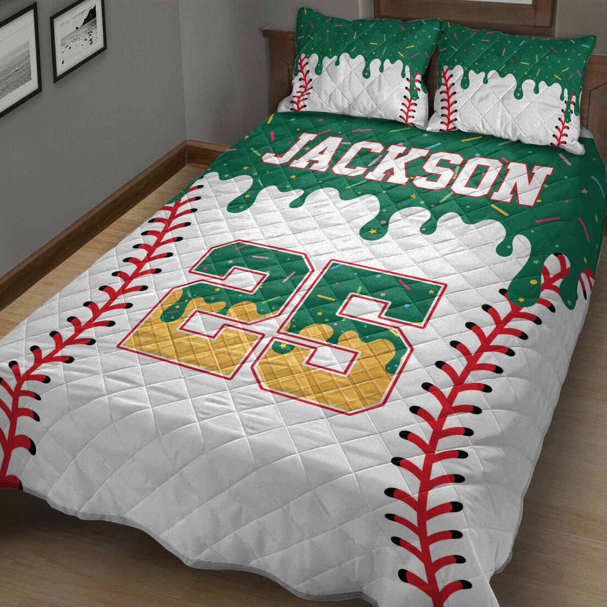 Green baseball quilt blanket displayed on a bed with red stitching borders and colorful sports accents