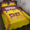 Softball quilt blanket displayed on a bed with yellow and burgundy sports artwork