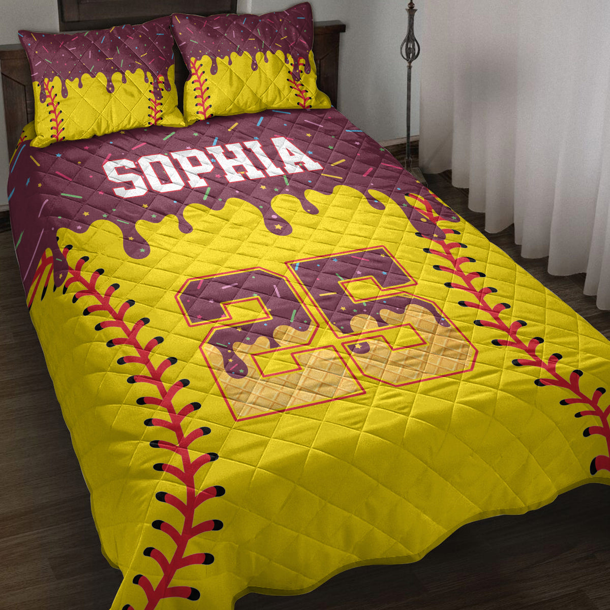 Softball quilt blanket displayed on a bed with yellow and burgundy sports artwork