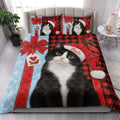 Tuxedo cat Christmas quilt blanket styled on a bedroom bed with holiday tree, presents, lights, and snowflake patterns
