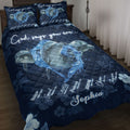Navy dolphin quilt blanket displayed on a bed with water-splash artwork, floral accents, and inspirational messaging
