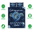Dolphin quilt bedding set shown front-facing with navy floral artwork and soft breathable bedding feature icons