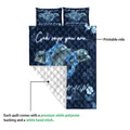 Dolphin quilt blanket showing the printed front design, white quilted backing, and layered construction