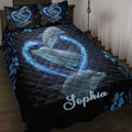 Dolphin quilt blanket featuring blue dolphins, glowing wave hearts, floral accents, and a dark navy background