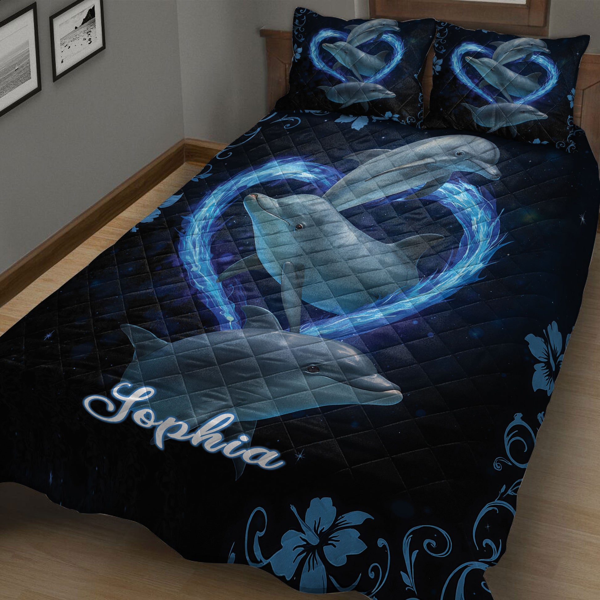 Dolphin quilt blanket displayed on a bed with blue dolphins, swirling waves, and navy floral borders