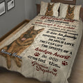 Close view of German Shepherd quilt blanket with realistic dog portraits, paw prints, and inspirational wording