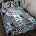 Hockey quilt blanket bedding set displayed on a bed with player silhouettes, pucks, sticks, and teal accents