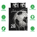 Soccer quilt bedding set shown front-facing with bold black and white ball artwork