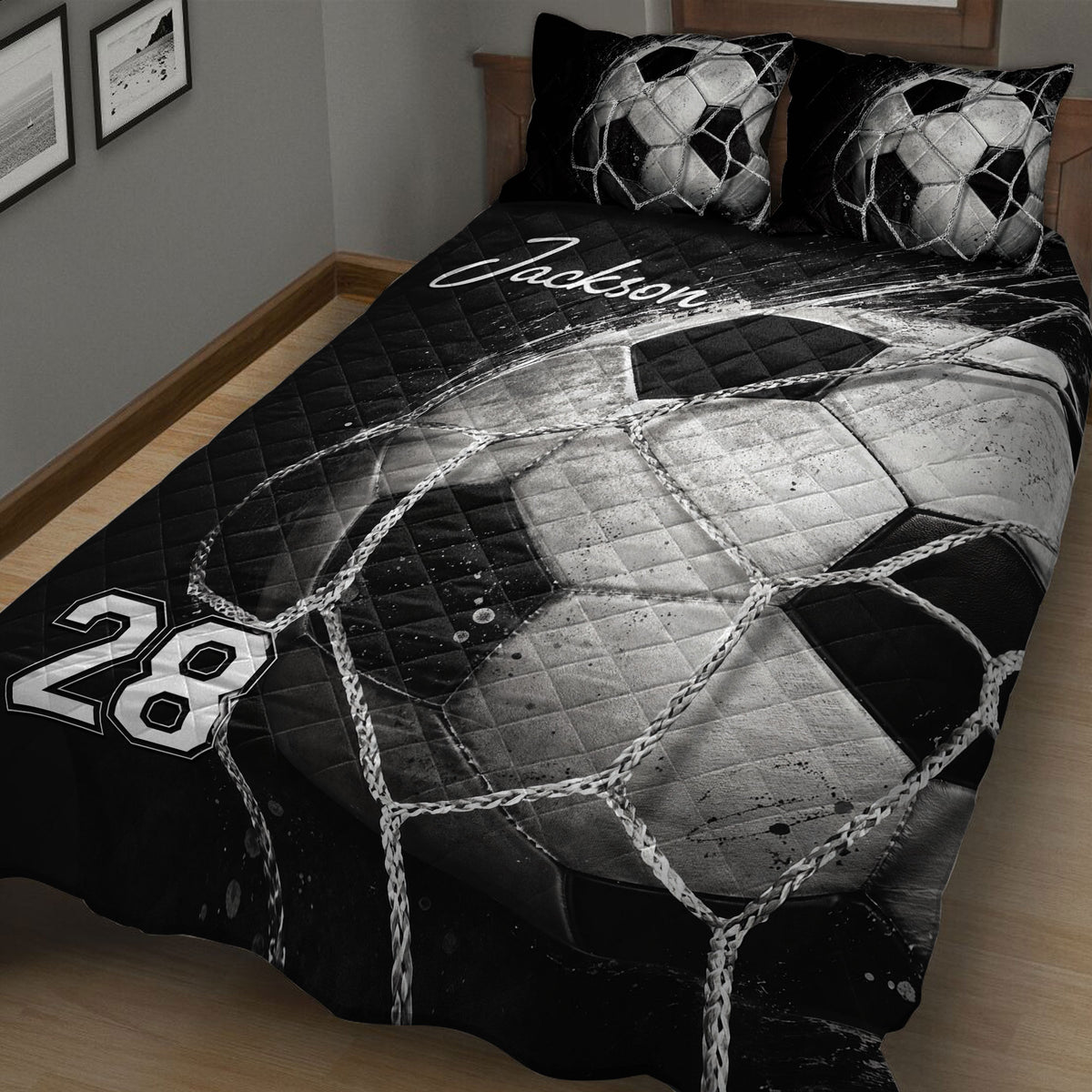 Close bedroom view of a black and white soccer quilt with ball and net design