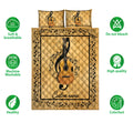 Guitar quilt bedding set shown flat with musical note artwork and a warm gold color palette