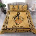 Music-themed guitar quilt blanket styled on a modern bed in a bright bedroom