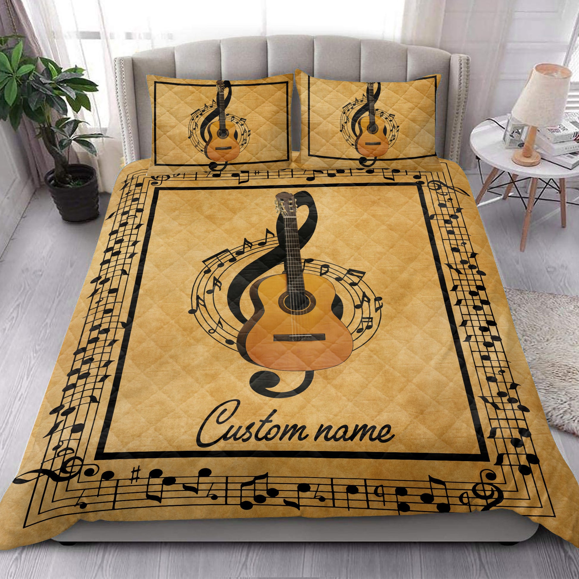 Music-themed guitar quilt blanket styled on a modern bed in a bright bedroom