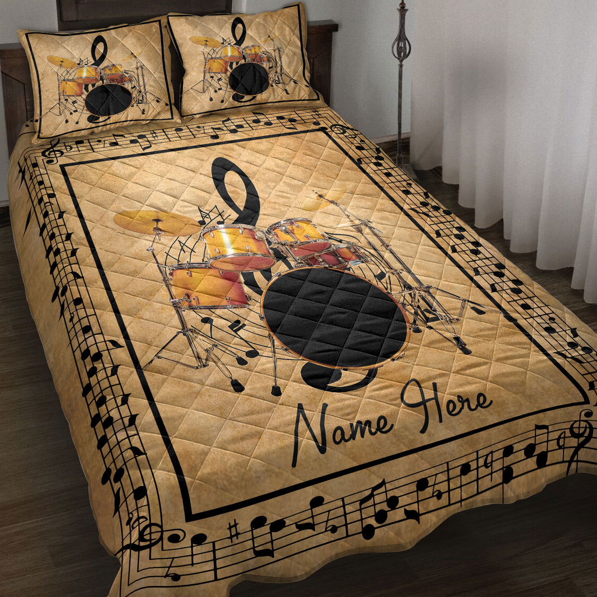 Drum set quilt blanket displayed on a bed with musical notes, gold tones, and black music-themed borders