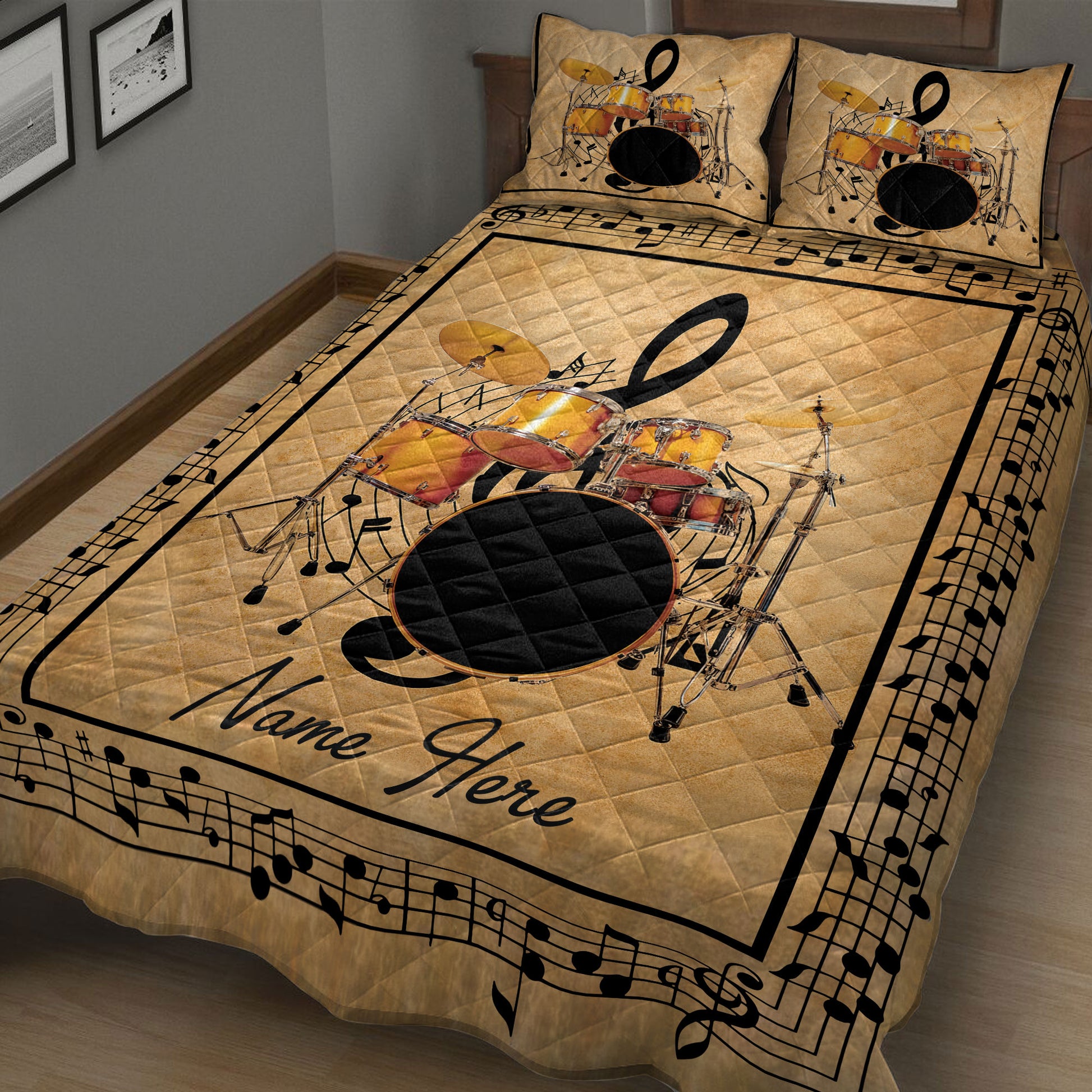 Close view of drum set quilt blanket featuring cymbals, drums, musical notes, and a black border