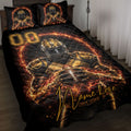 Black and gold football quilt blanket displayed on a bed with fiery artwork and football player imagery