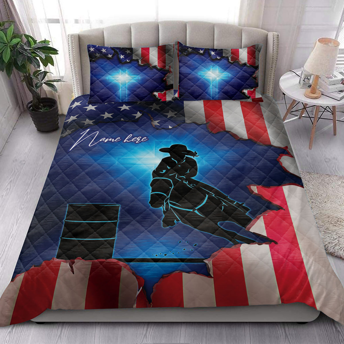 Patriotic barrel racing quilt styled on a bedroom bed with glowing blue cowgirl rider and barrel design