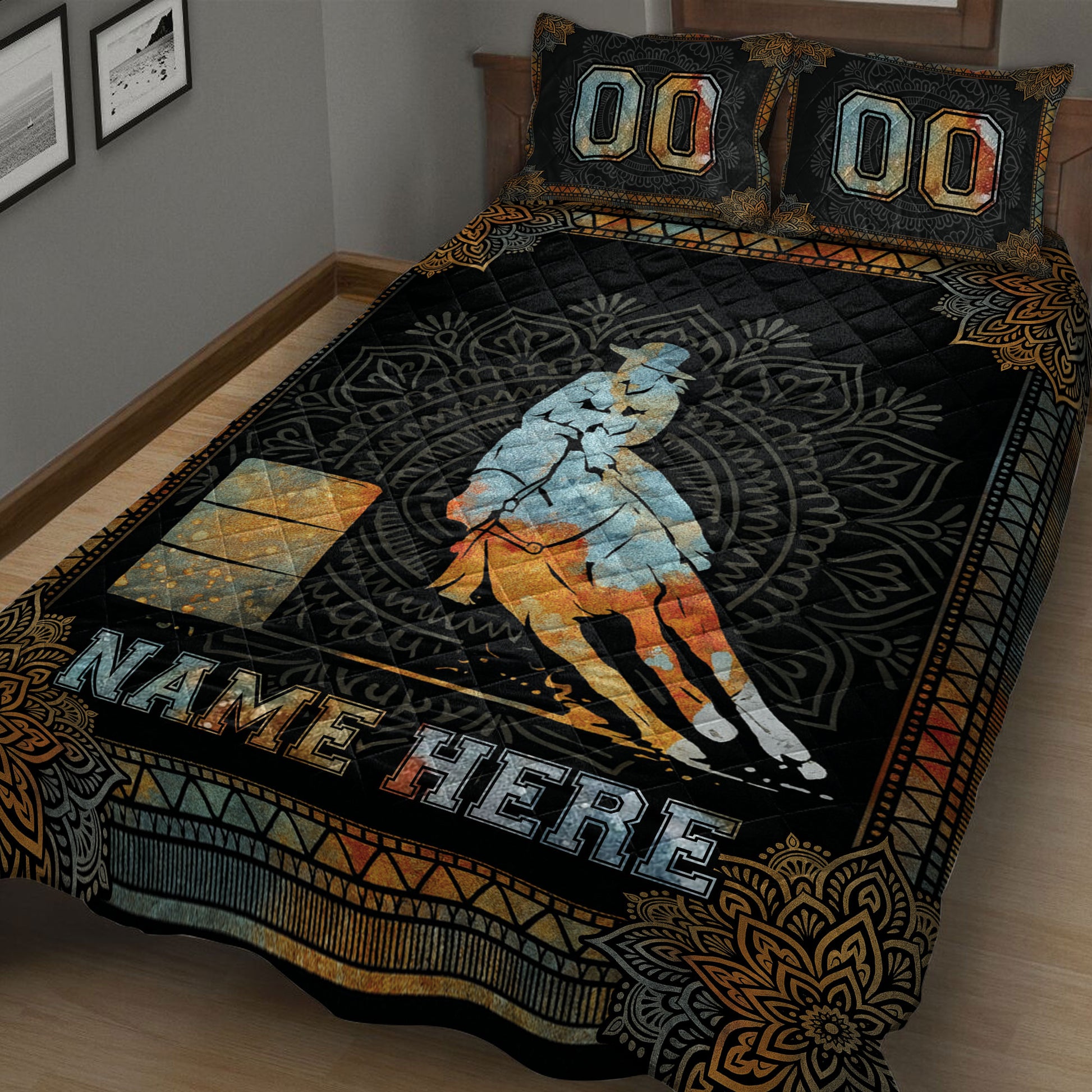 Close view of a black and gold barrel racing quilt blanket featuring a horse, rider, barrels, and decorative border