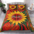 Colorful hippie quilt blanket styled on a bedroom bed with sunflower, peace sign, and bohemian artwork