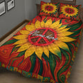 Close bedroom view of a hippie quilt blanket with large sunflower artwork, peace symbols, and swirling colors