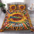 Hippie quilt bedding styled in a bright bedroom with sunflower, peace, and boho artwork