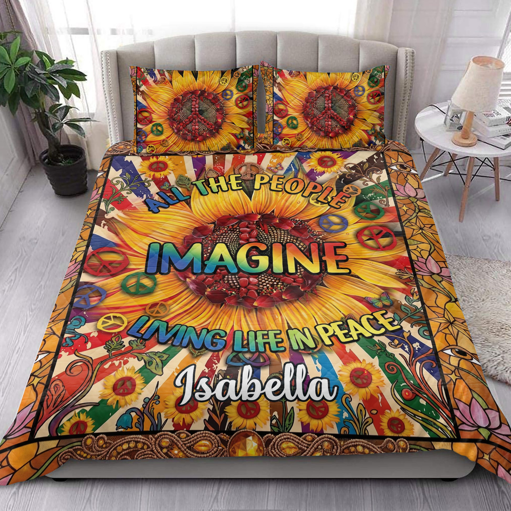 Hippie quilt bedding styled in a bright bedroom with sunflower, peace, and boho artwork