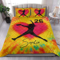 Colorful softball quilt bedding styled in a bright bedroom with female player silhouette artwork