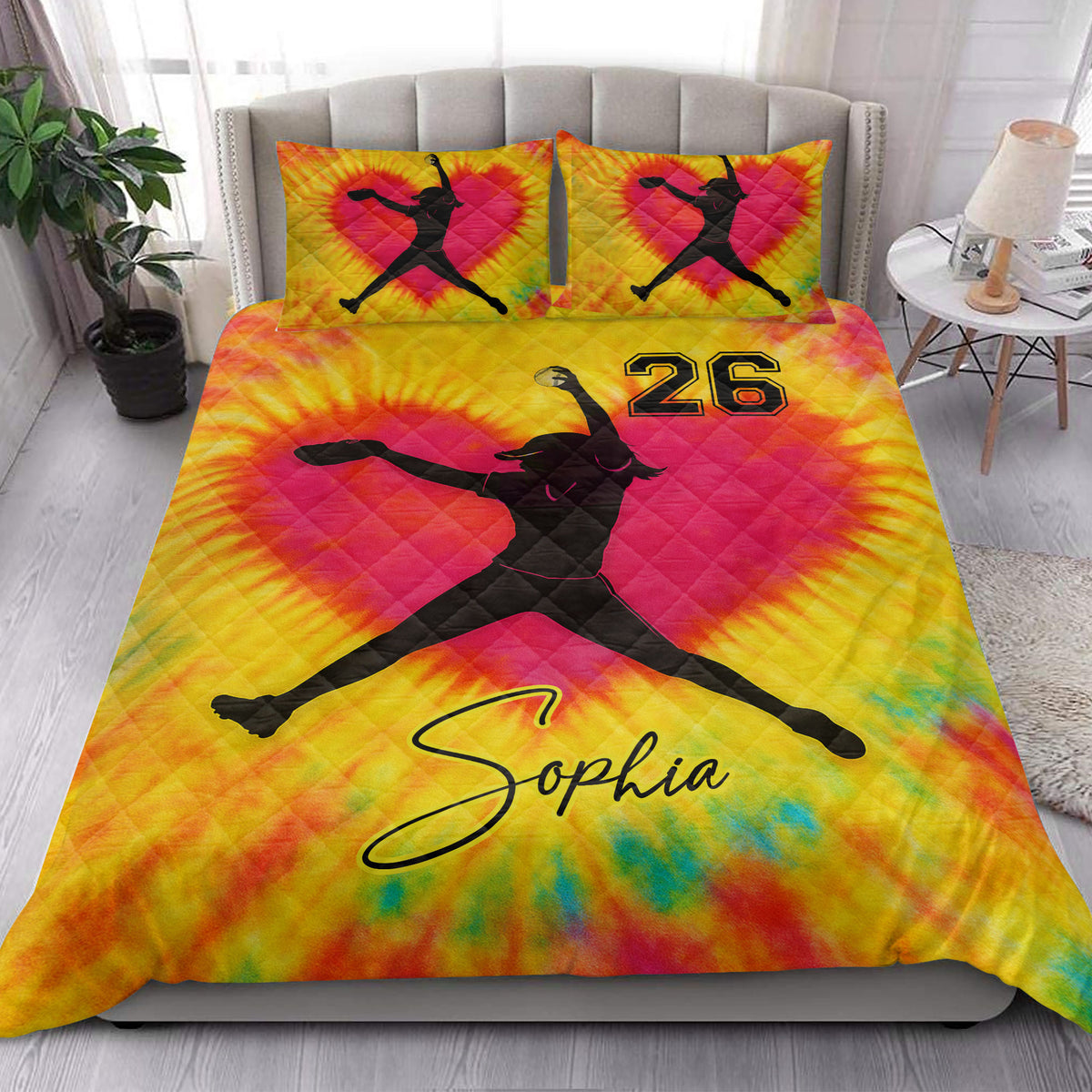 Colorful softball quilt bedding styled in a bright bedroom with female player silhouette artwork