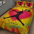 Vibrant softball quilt blanket on a bed featuring a female softball player silhouette and bold sports design
