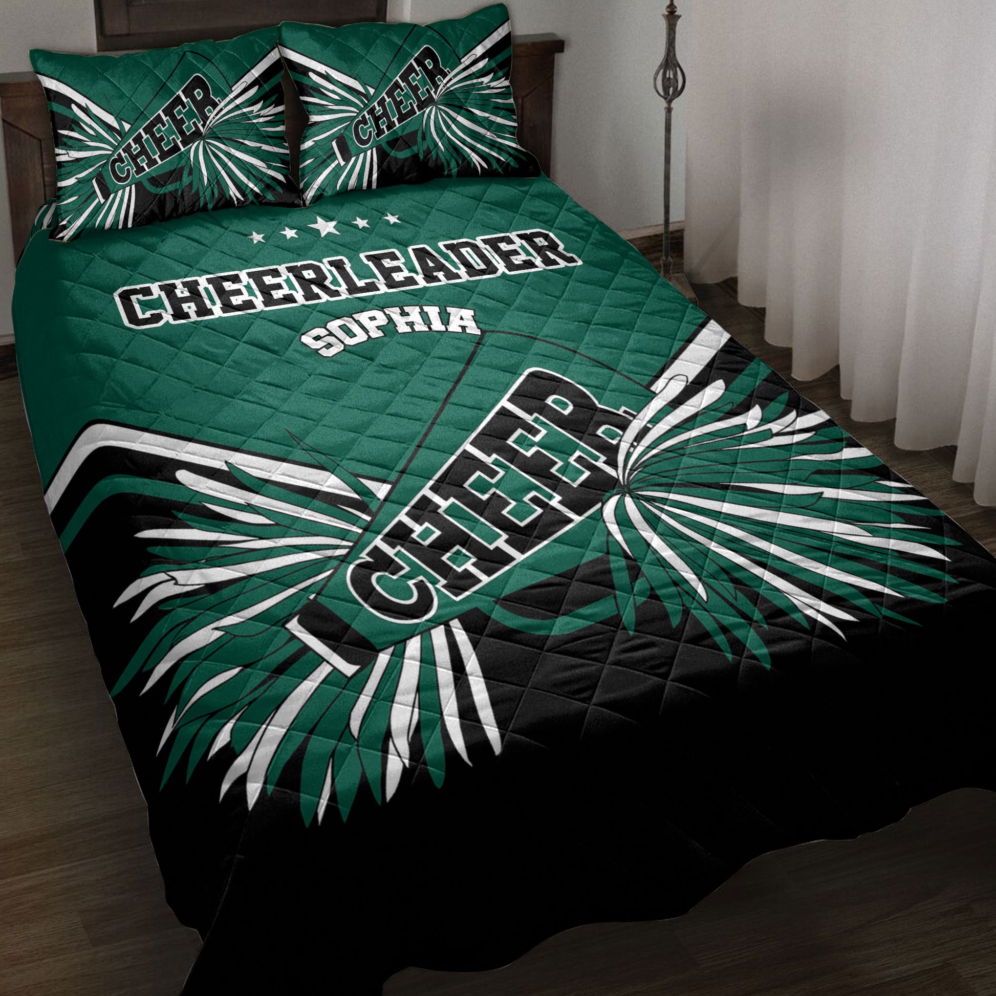 Green, black, and white cheerleader quilt blanket styled on a bed with bold pom-pom artwork