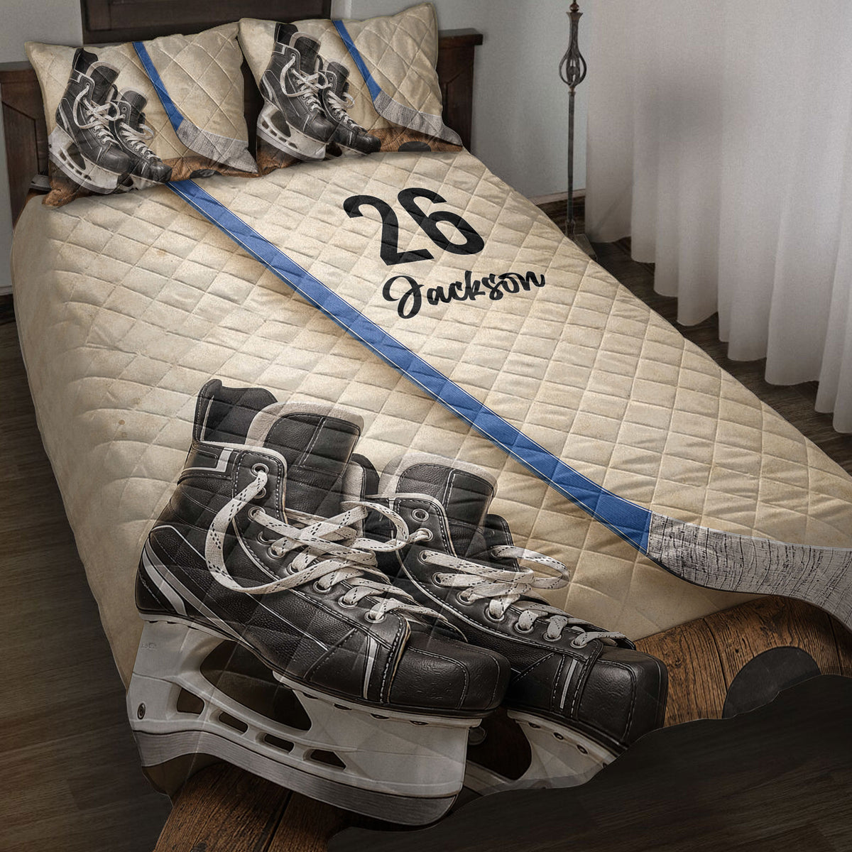 Hockey quilt blanket displayed on a bed with hockey skates, sticks, and blue rink-inspired accents