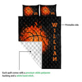 Basketball quilt blanket shown with a printed black front and white quilted polyester backing