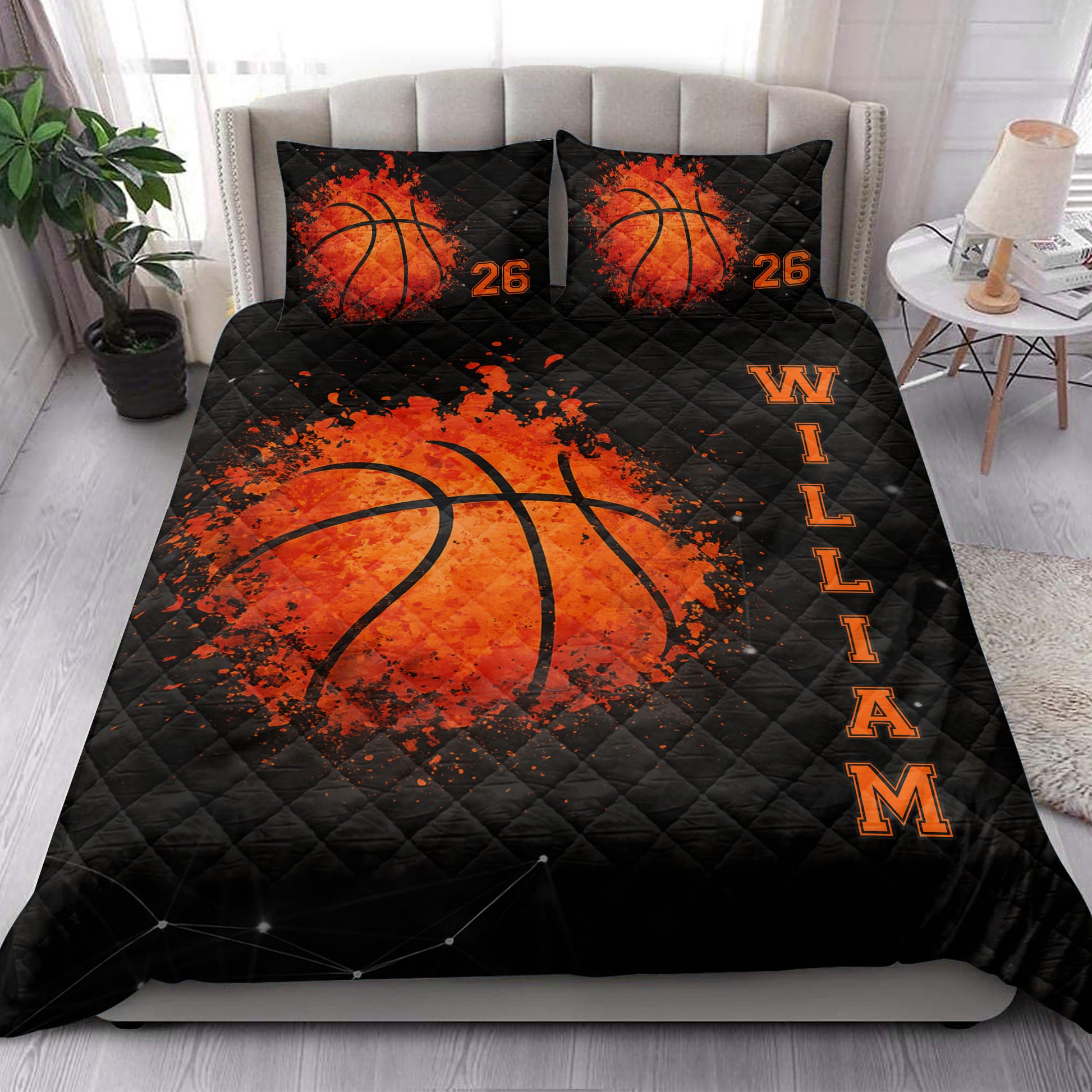 Basketball quilt bedding set styled on a bedroom bed with bold orange and black sports artwork